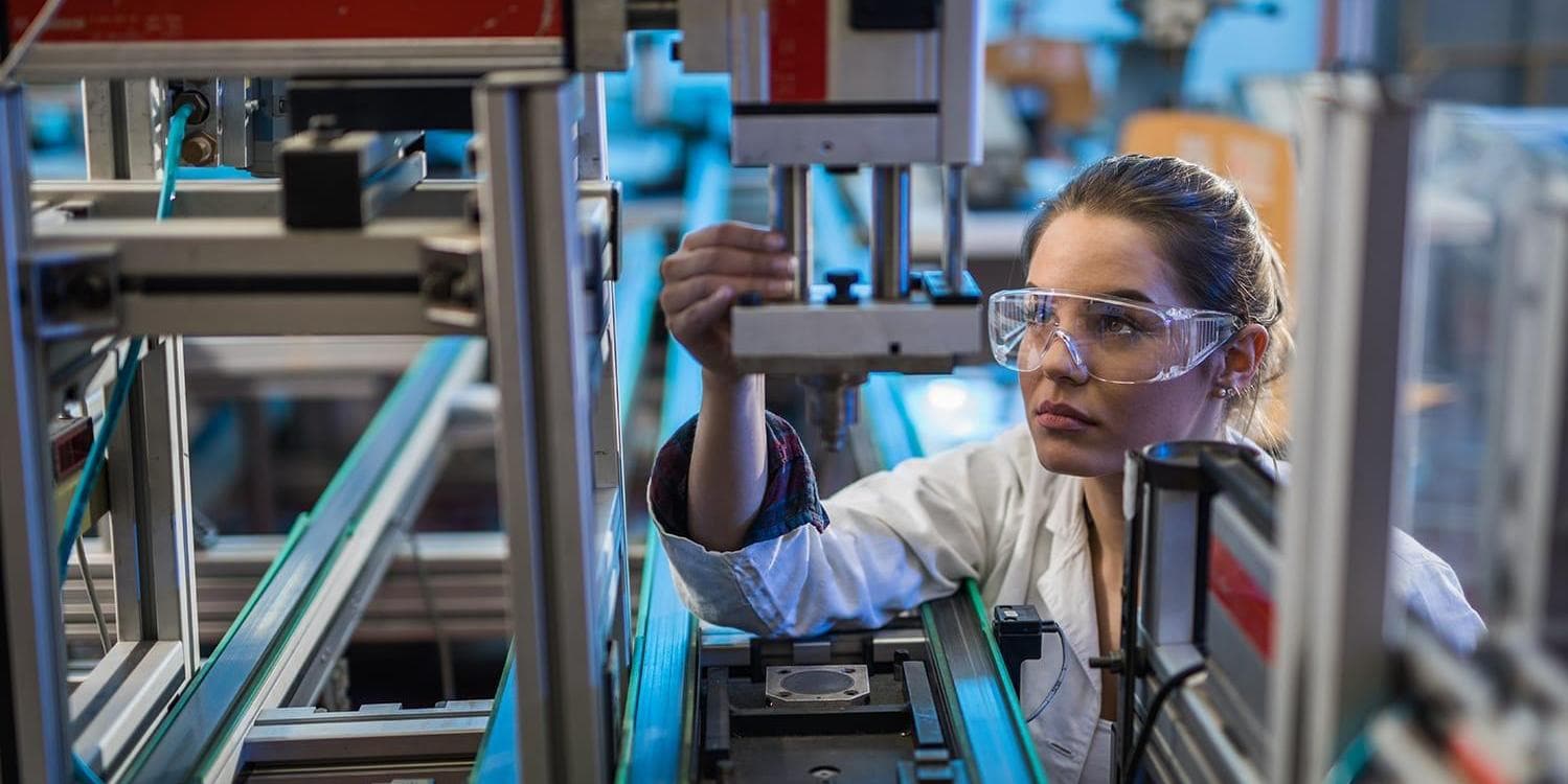 Quality control worker analyzing machine part in laboratory