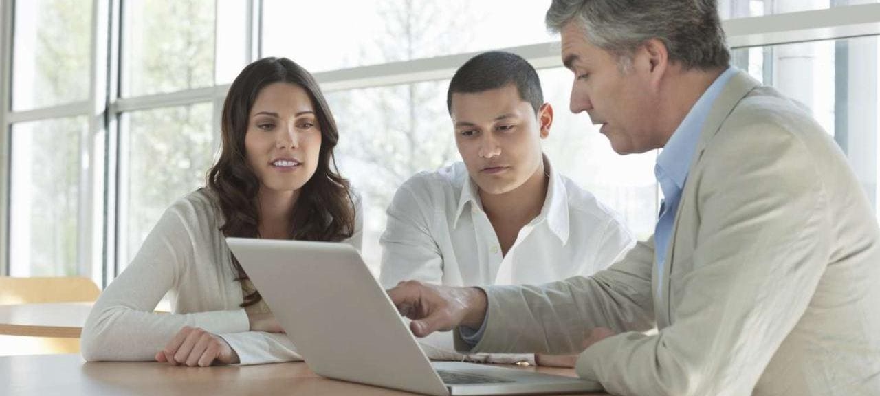 Man Explaining an Investment Plan To Couple Man Explaining an Investment Plan To Couple