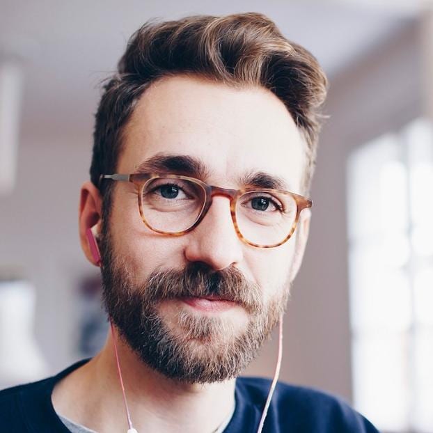 Man in glasses with beard and headphones