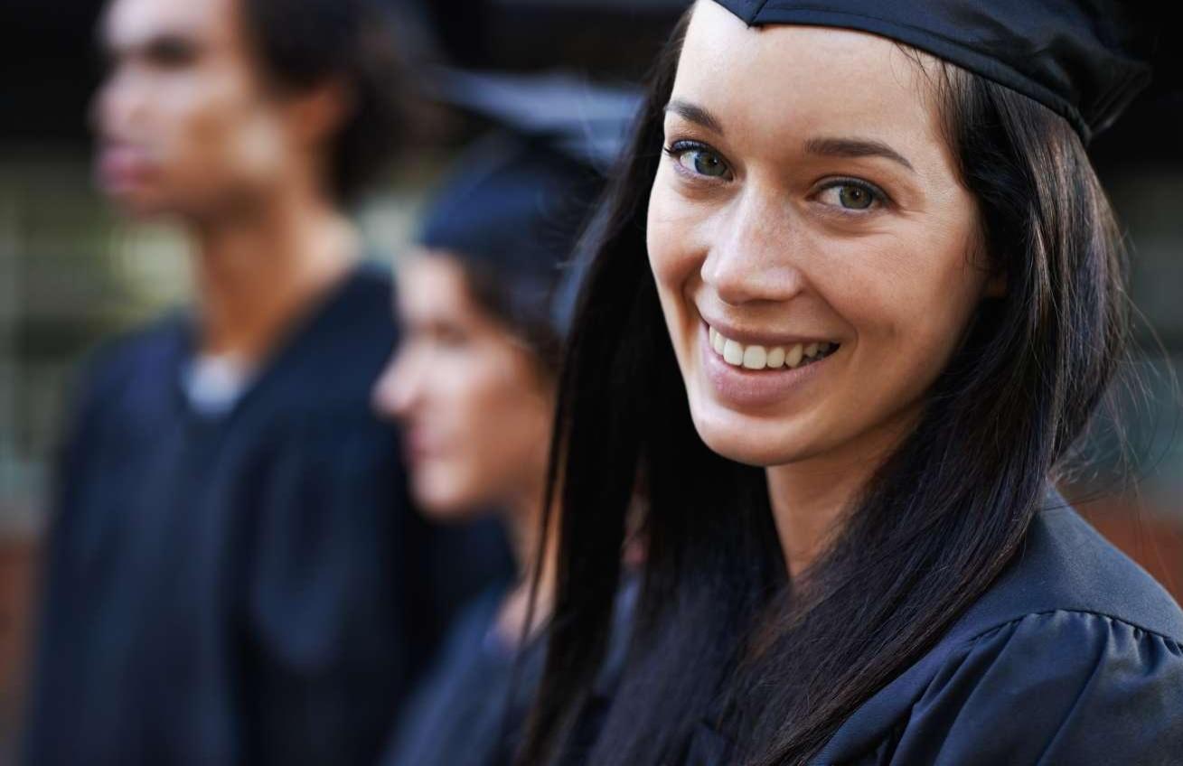 Young College Graduate Smiling At Camera