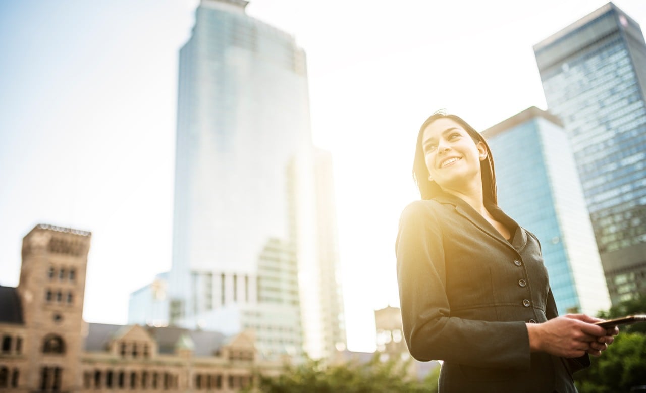  Business woman with arm crossed on urban scene