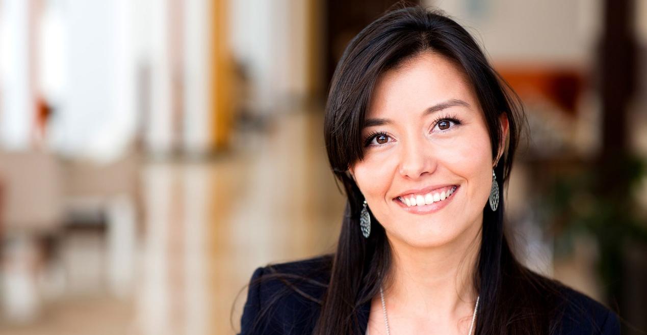 Headshot of business woman smiling in office setting Headshot of business woman smiling in office setting