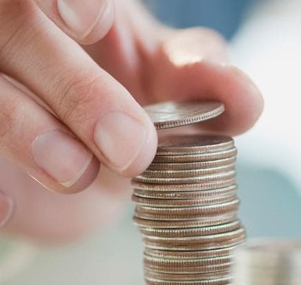 man stacking coins