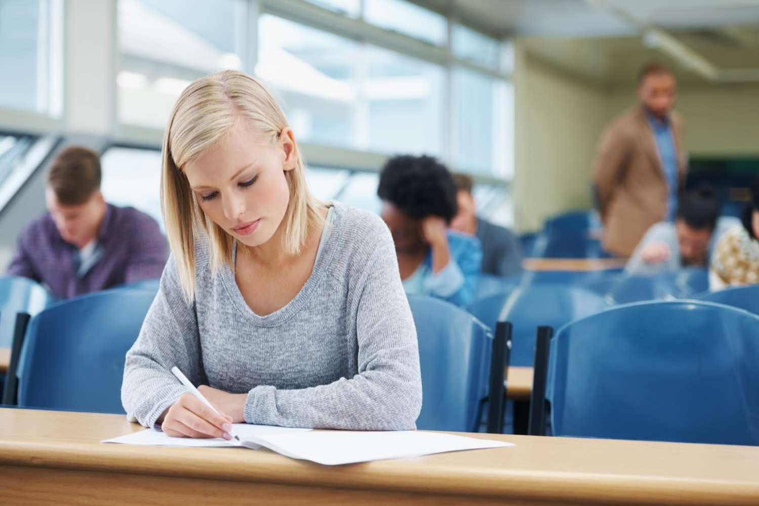 Young woman taking a test in classroom