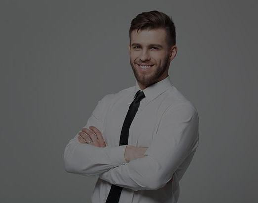 Young business man smiling at camera and crossing arms