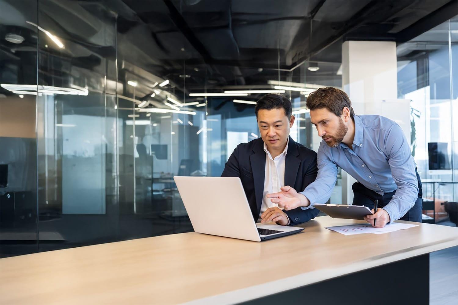 Two businessmen serious and concentrated, discussing strategy an Two businessmen serious and concentrated, discussing strategy an