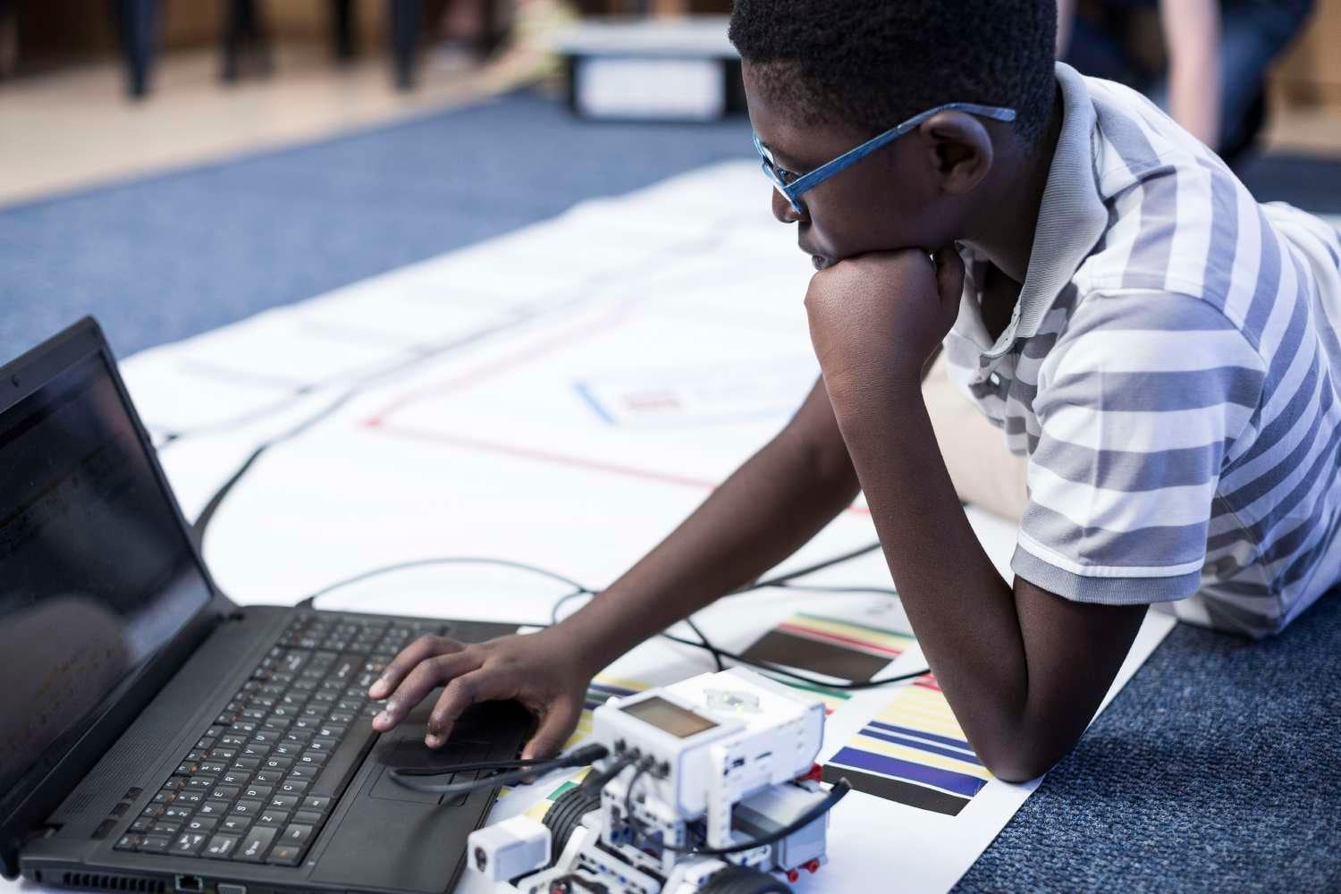 Young african american student programming robotics