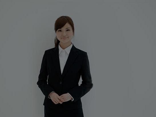 Young businesswoman wearing suit jacket smiling at camera