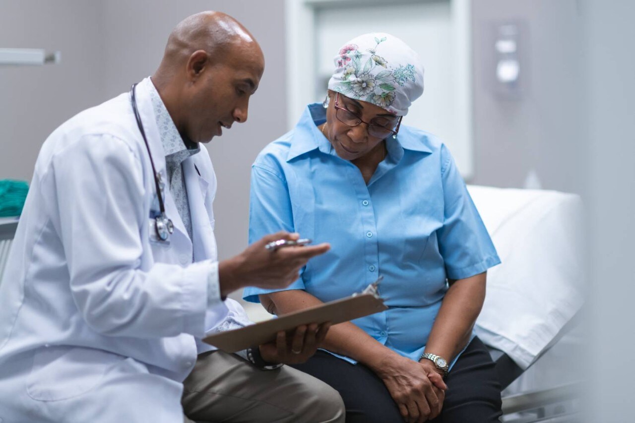 A doctor reviews a chart with a patient