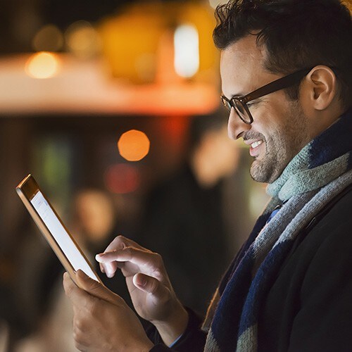 smiling-man-looking-at-tablet