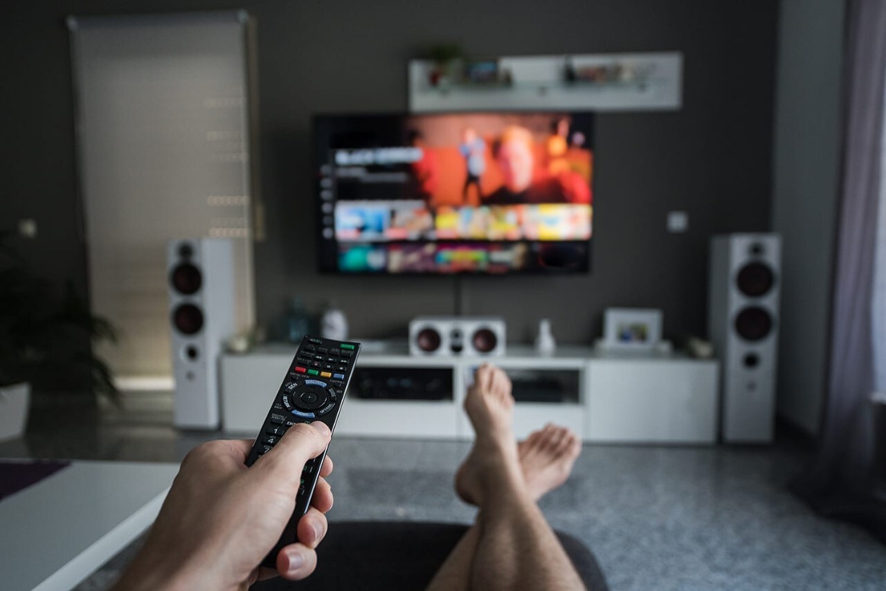 Young man browsing through television channels