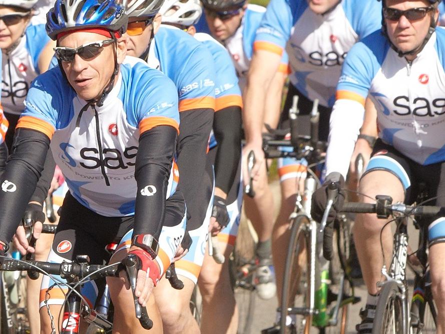 SAS-sponsored cycling team biking in group