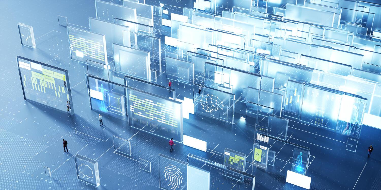 People surrounded by interactive screens showing charts and data