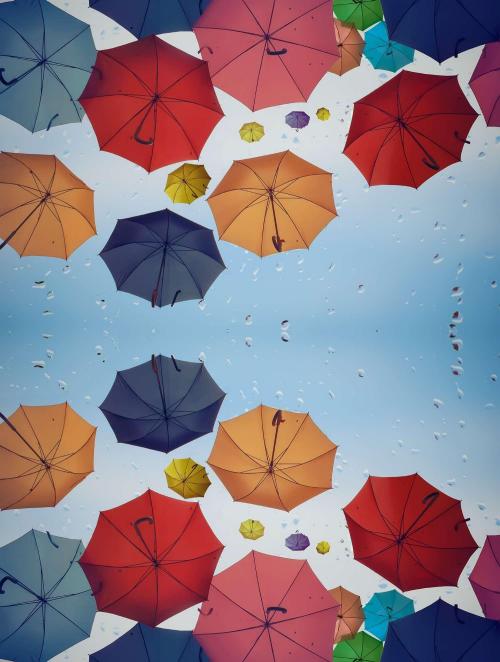 Colorful umbrellas floating in the air on a rainy day