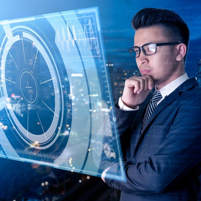 Abstract image of businessman looking at hologram