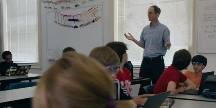 Male teacher standing in the middle of his classroom