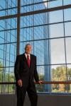 Jim Goodnight in front of wall of windows