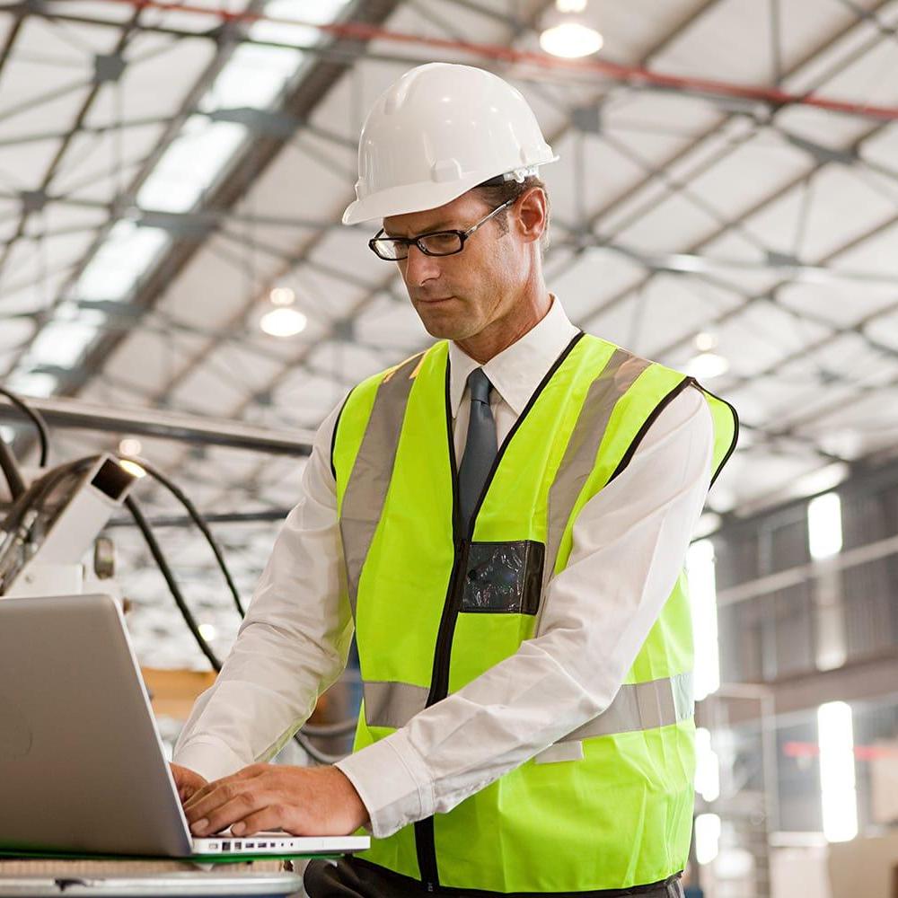 Businessman with hard hat and laptop