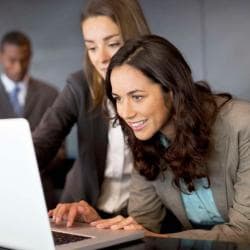 Business Women Looking at Laptop