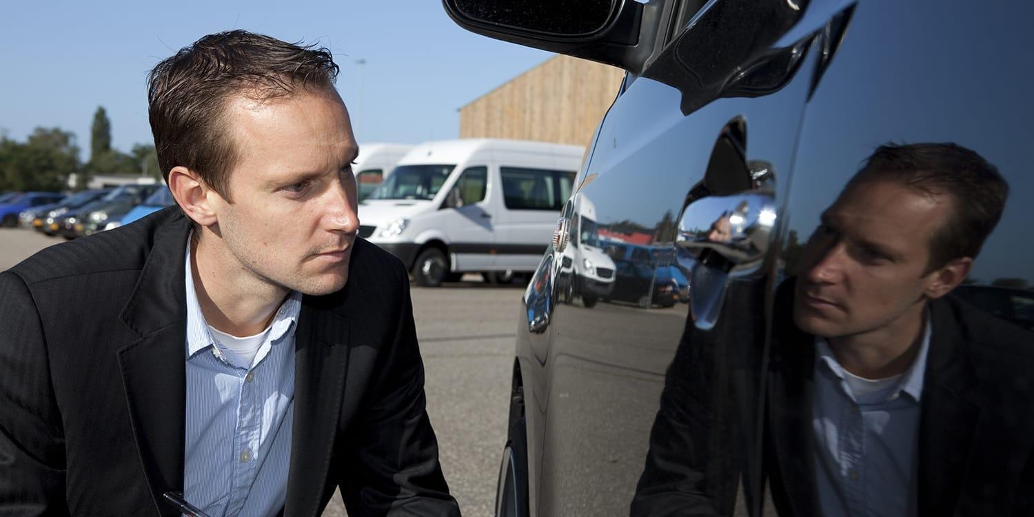 Insurance agent examining car damage