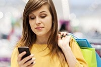 Article: IDC: Tons of Customer Data Going to Waste Female shopping with cell phone