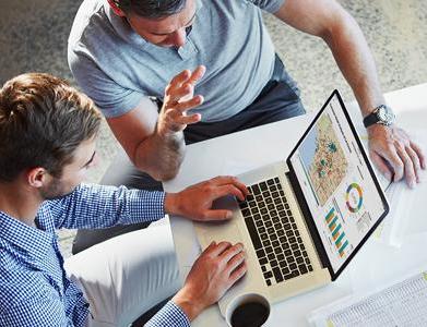 Two young business men review visualized data using SAS® Visual Analytics