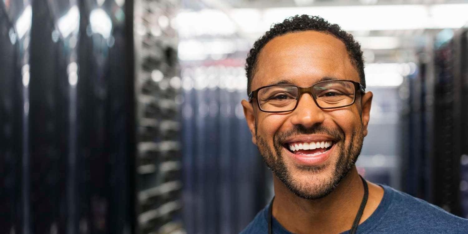 man with glasses and beard smiling at the camera man with glasses and beard smiling at the camera
