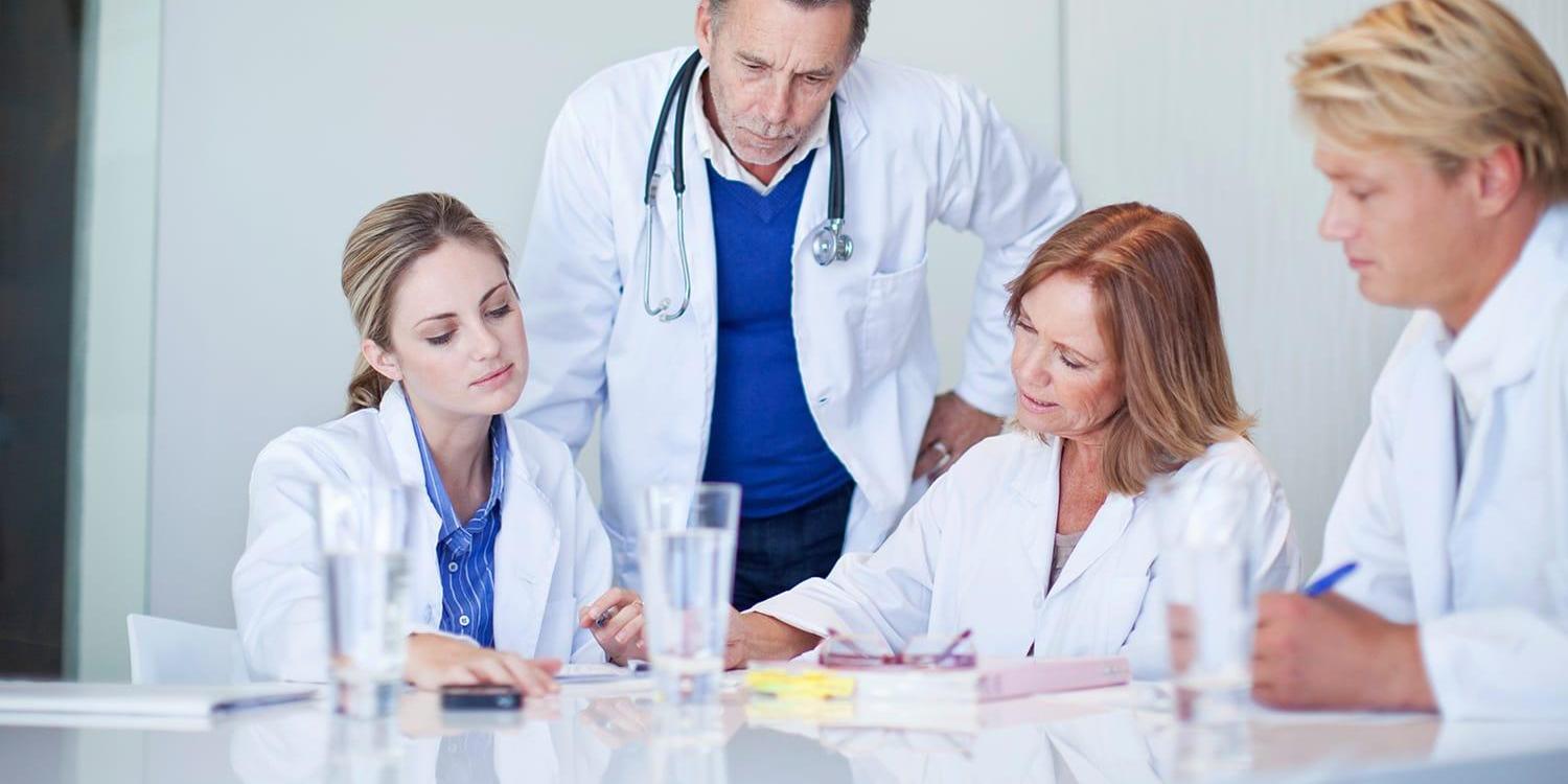 Group of medical professionals conferring in a meeting  