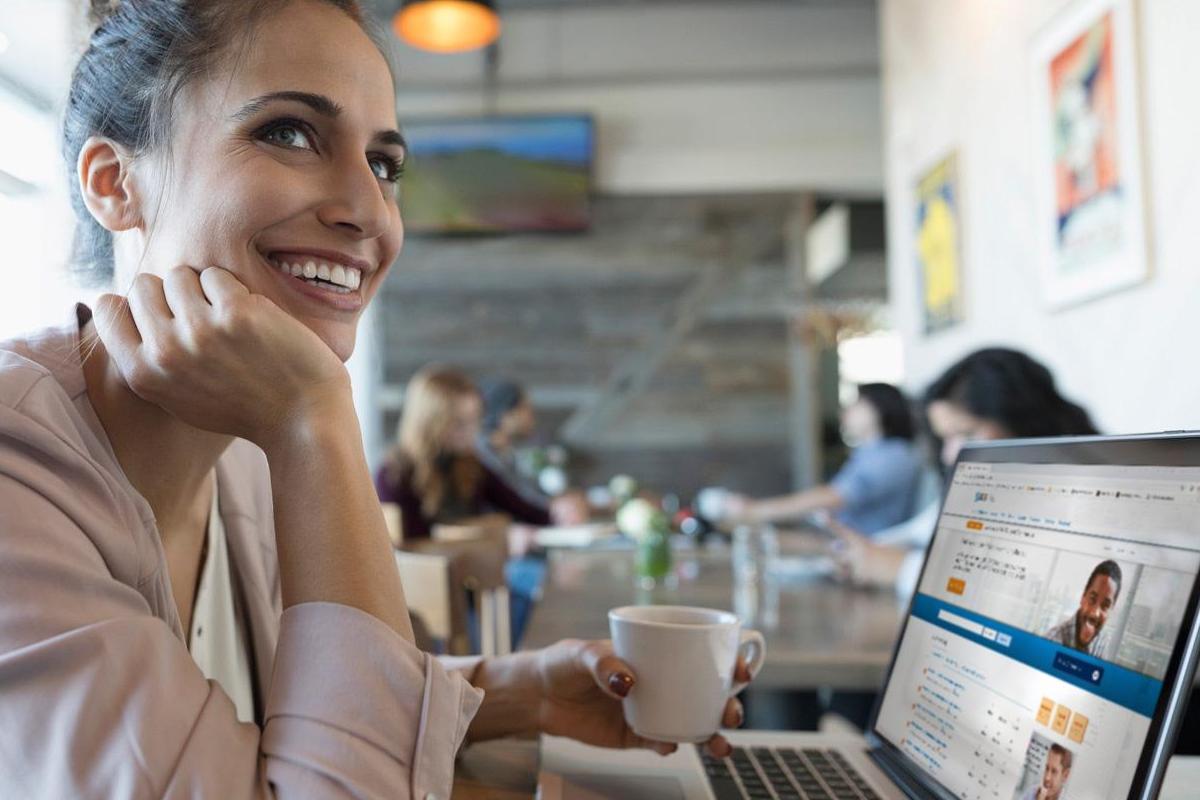 Woman at computer sitting in cafe