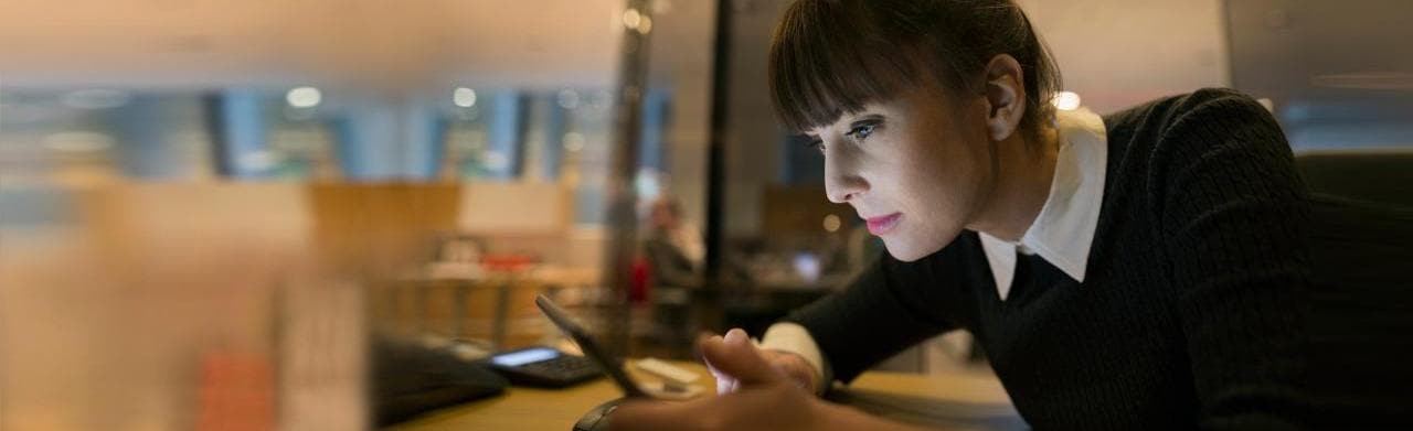 Woman staring intently at tablet device