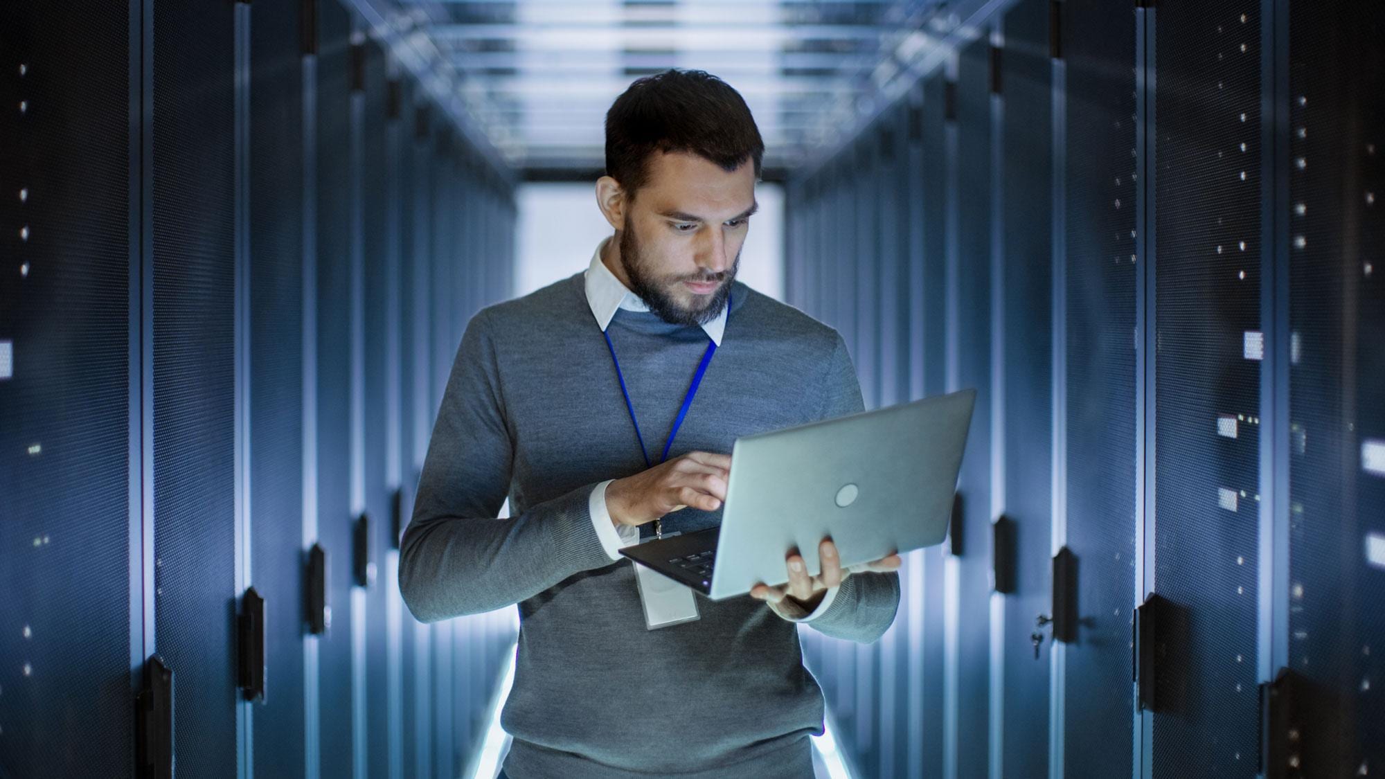 Man holding laptop in data warehouse Man holding laptop in data warehouse