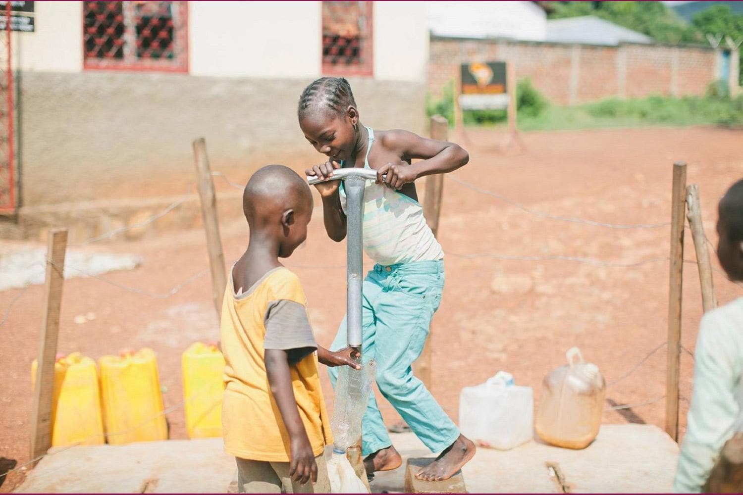 Two Kids Pumping Water from a Well