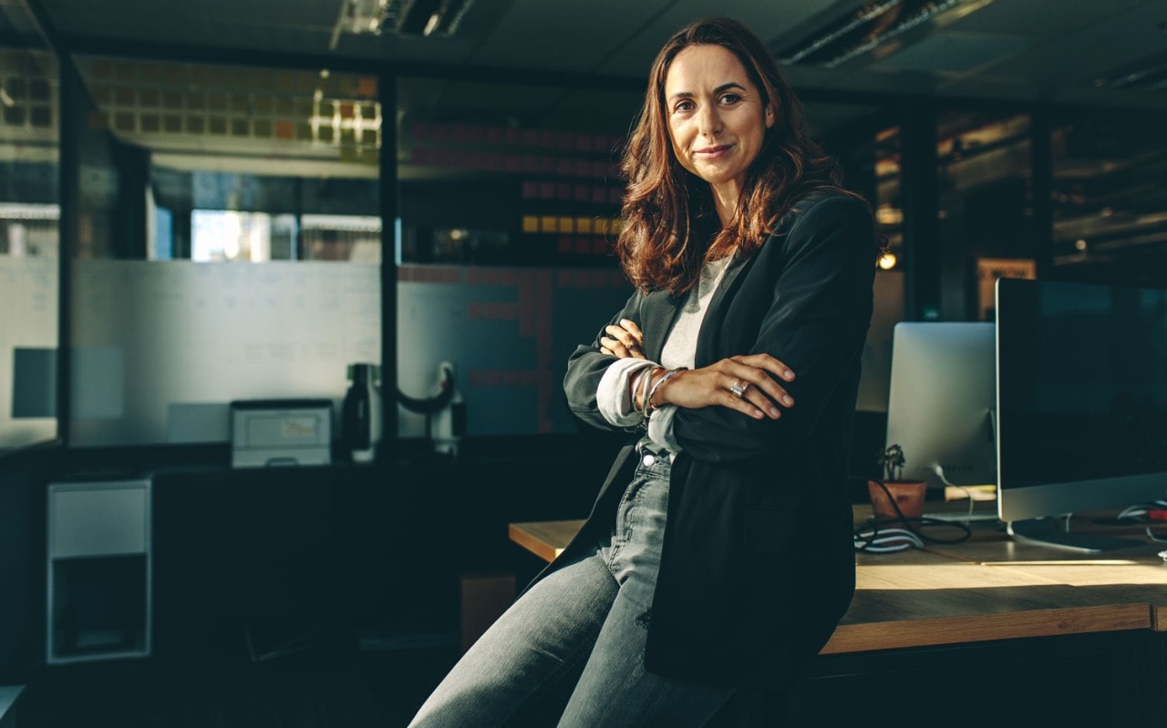 Mature business woman sitting on her desk