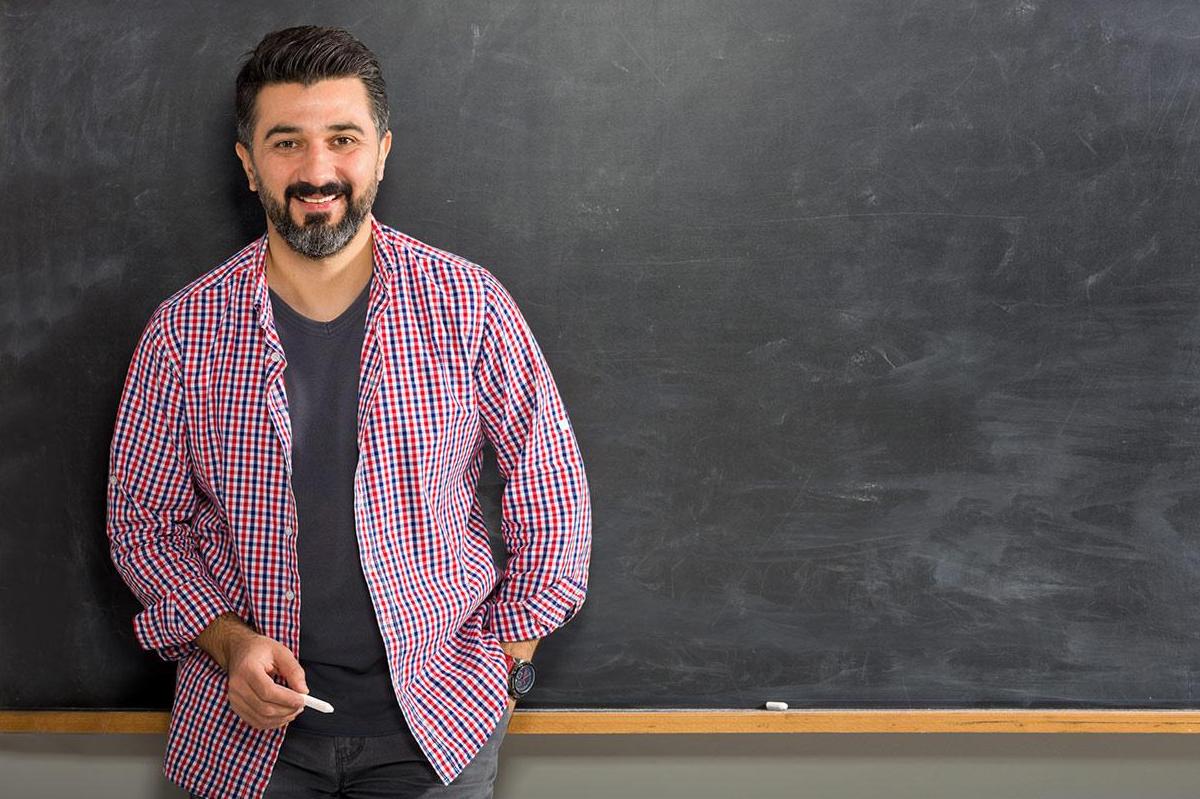 Bearded professor standing at chalkboard