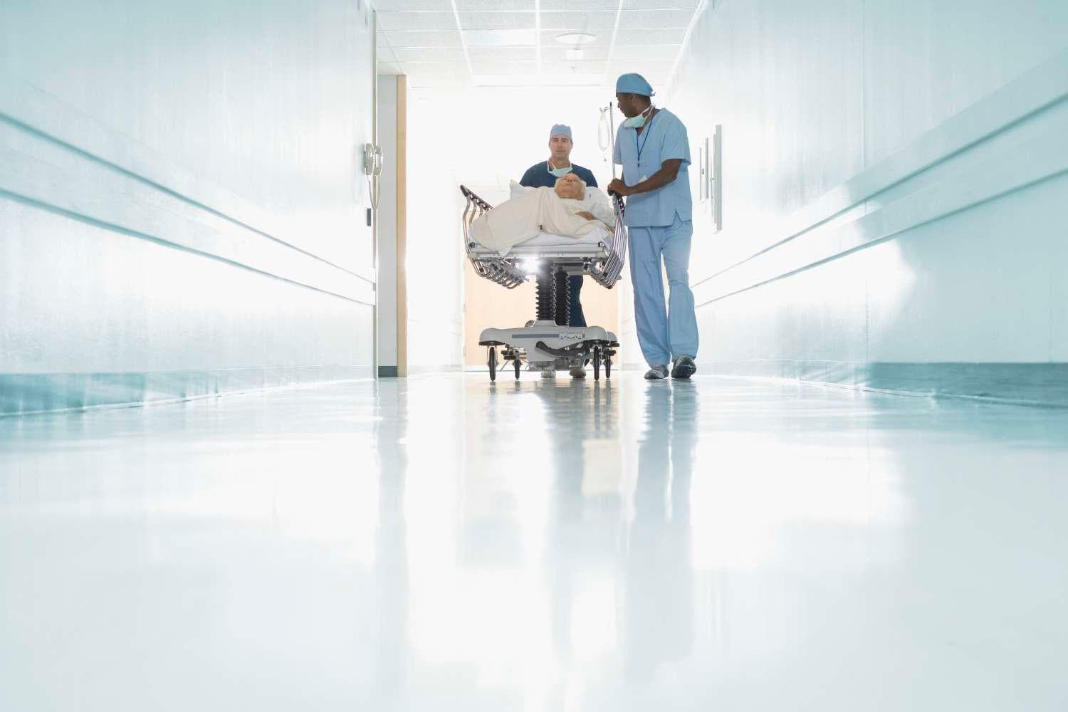 Medical staff pushing patient in gurney Medical staff pushing patient in gurney