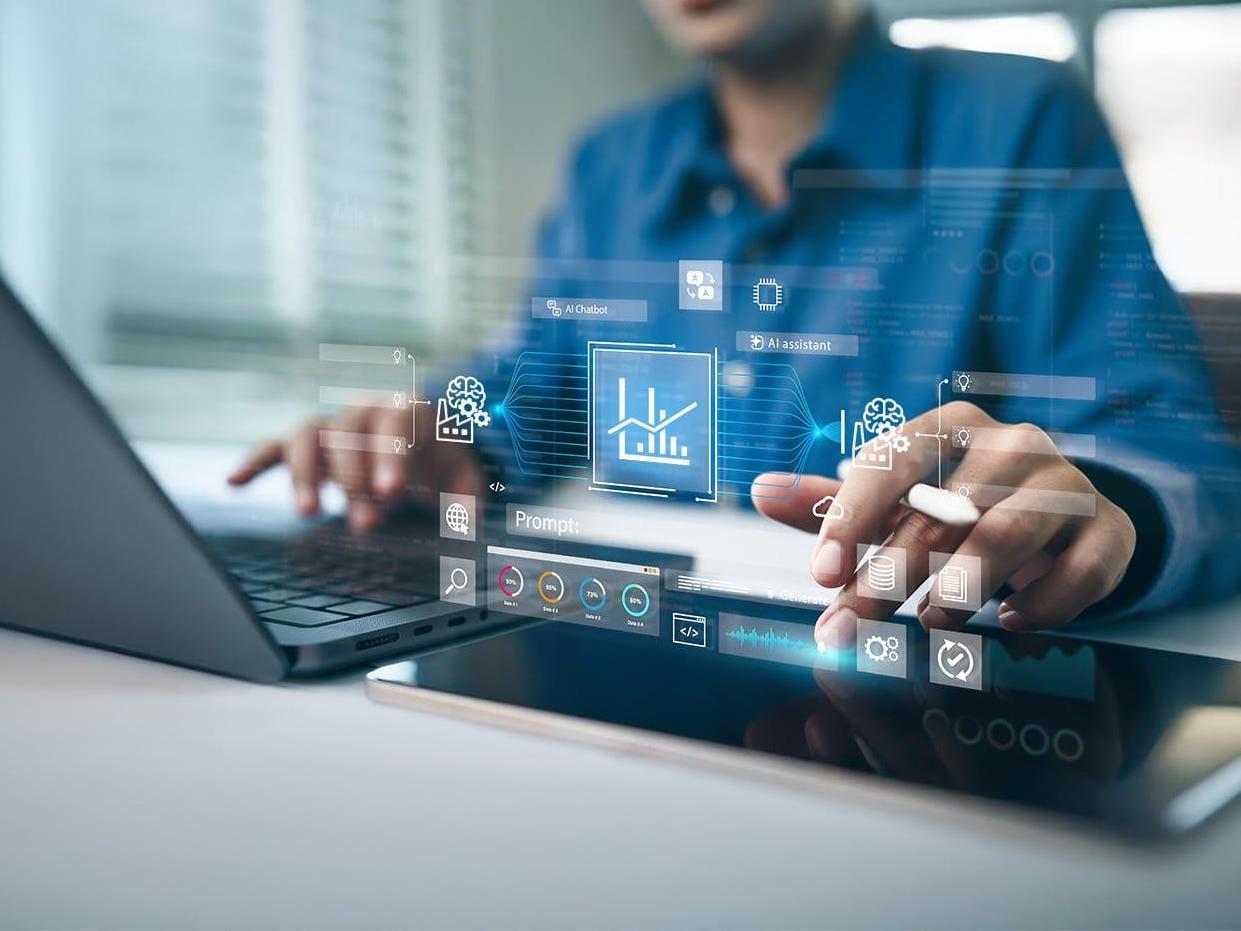 Woman using a laptop and AI assistant