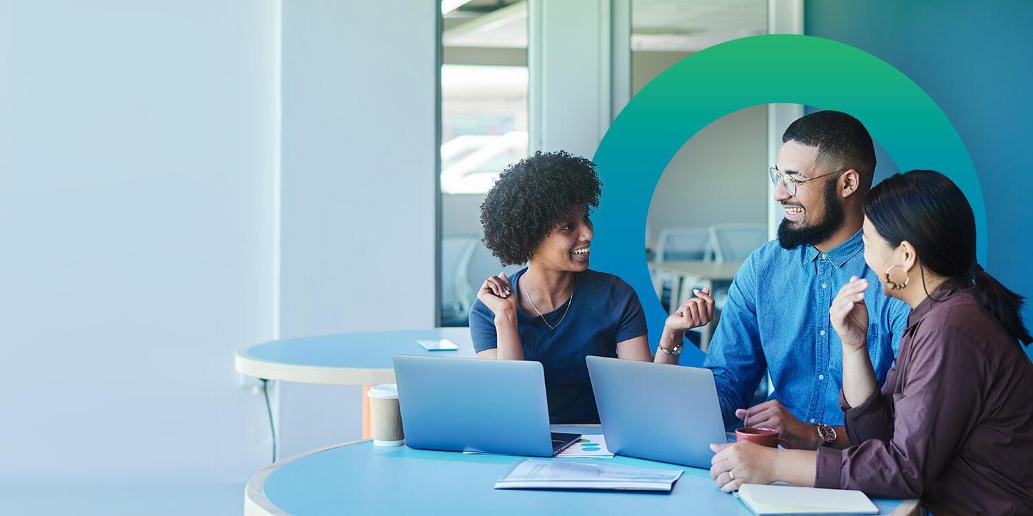 Three coworkers with laptops and circle orb