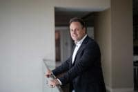 Portrait of Bryan Harris leaning on mezzanine rail