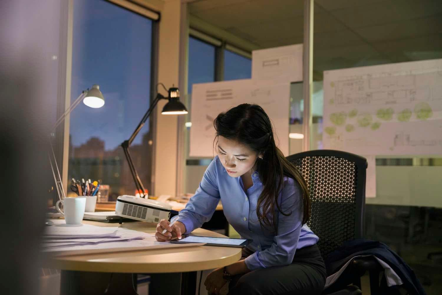 Young asian woman working late in office