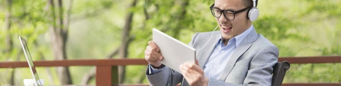 businessman watching video outside on mobile device