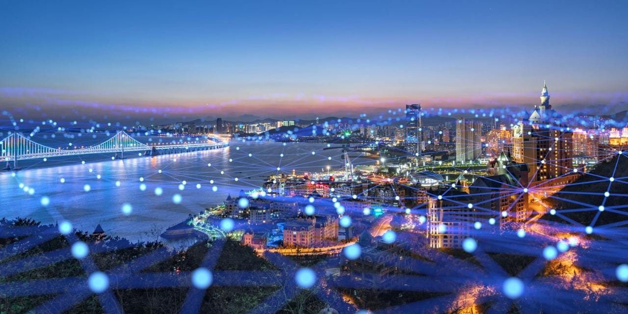 City skyline at night with blue grid network