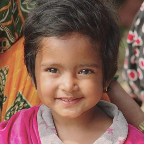 Napalese toddler girl smiling at camera