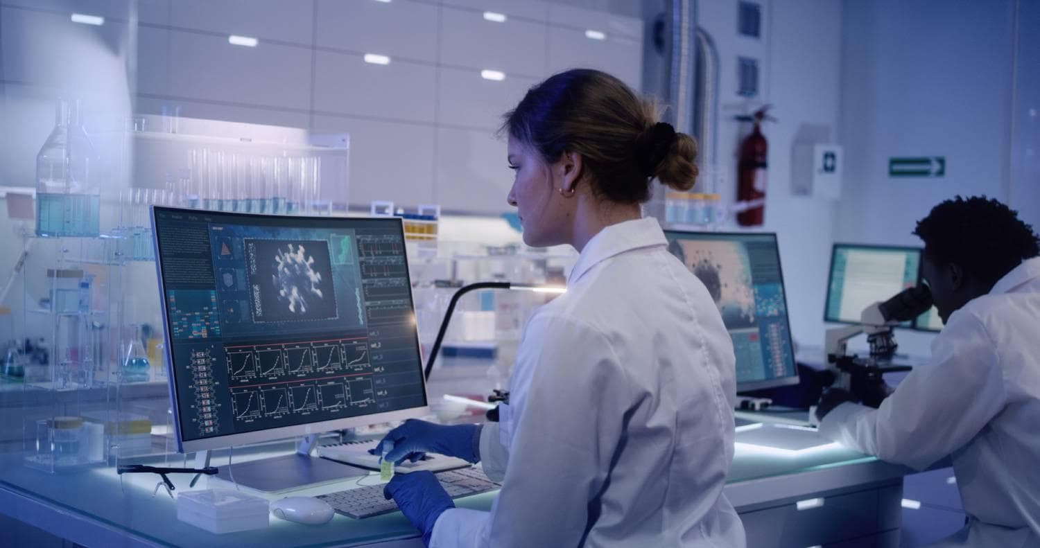 Female doctor looking at monitor in research laboratory