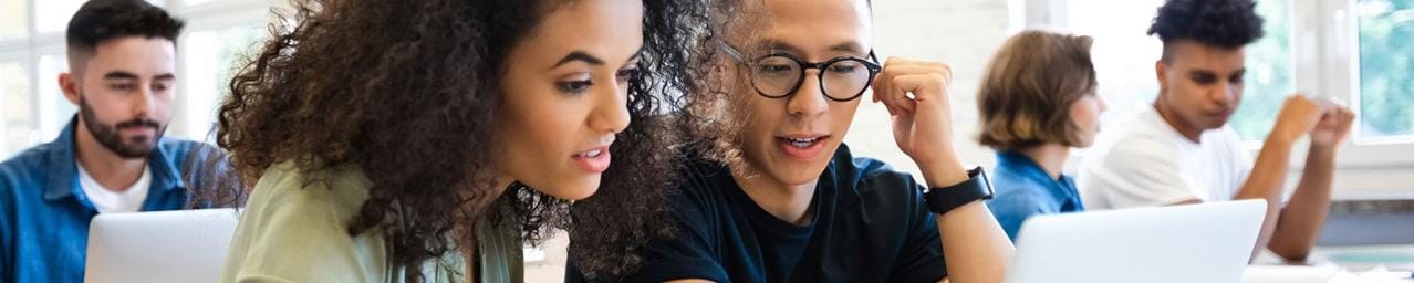 Pair of students working together at table