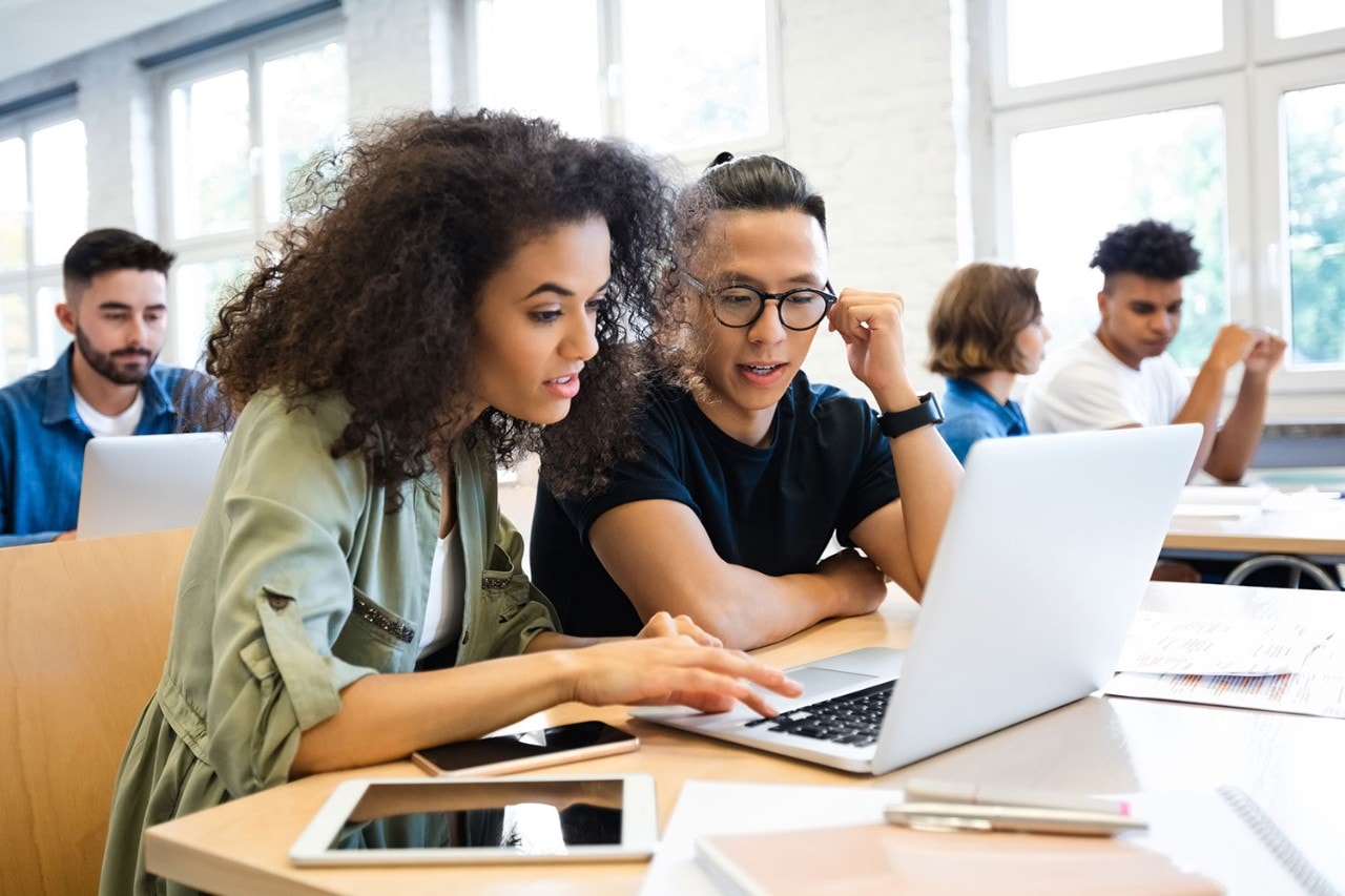 Pair of students working together at table