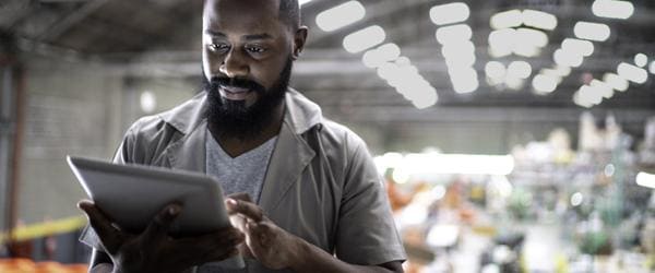 man on tablet in factory