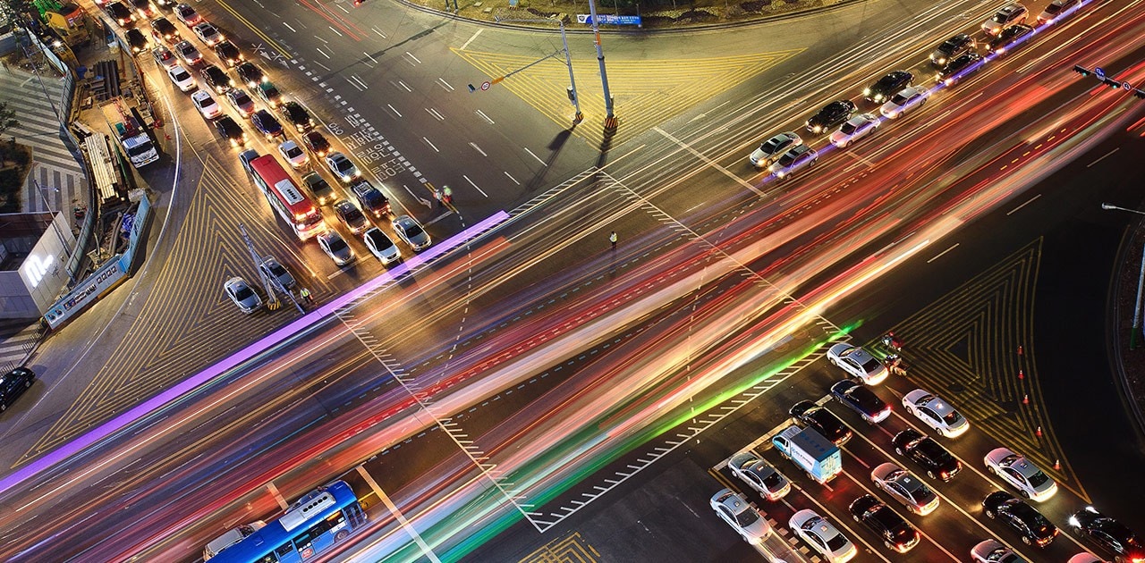 cars at busy intersection at night