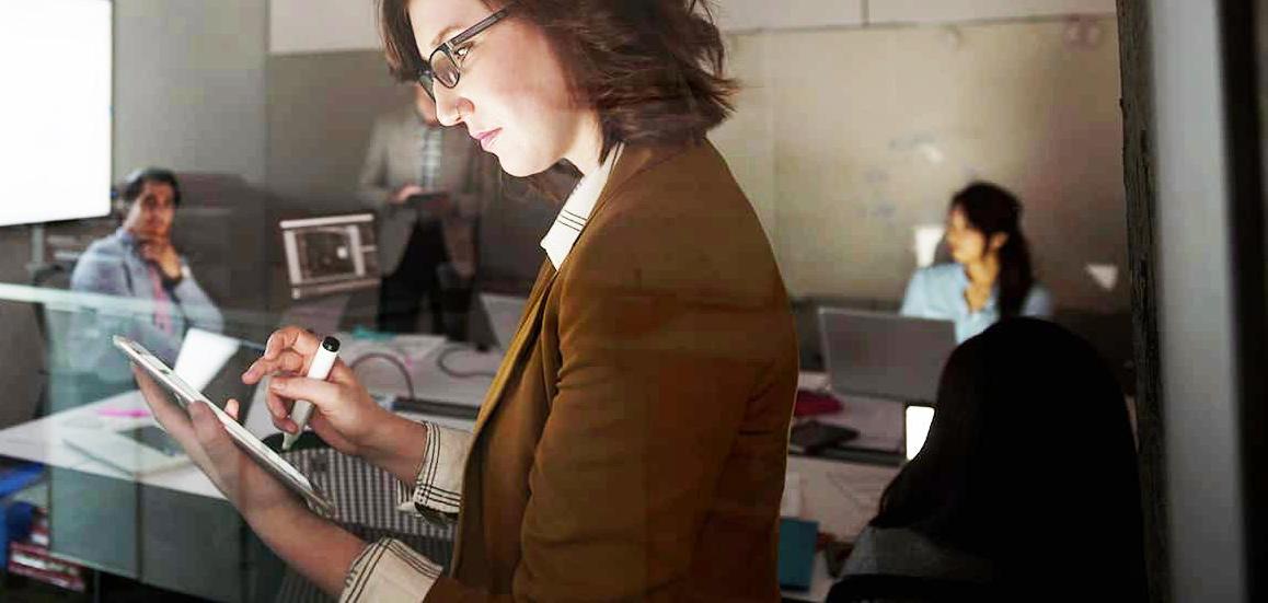 Business woman pointing at computer screen