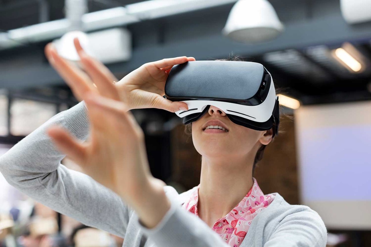 Woman wearing VR headset looking up