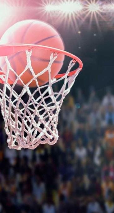 Basketball flying into a basket